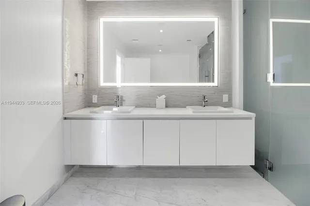 a bathroom with a sink vanity and mirror