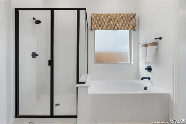 a en suite bathroom with a double sink shower and a mirror