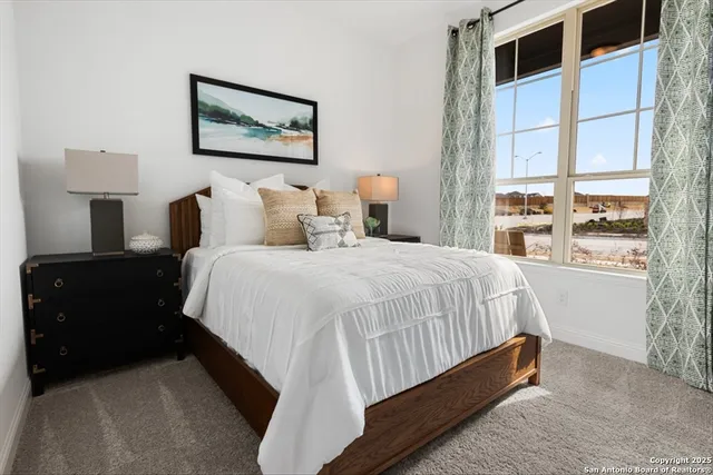 a spacious bedroom with a bed and window