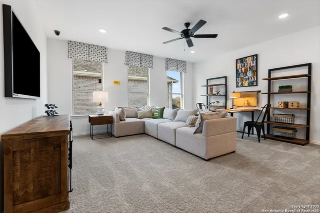 a living room with furniture and a chandelier