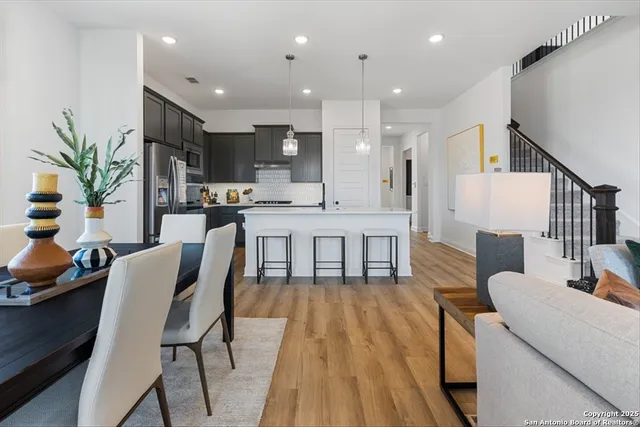 a kitchen with stainless steel appliances kitchen island granite countertop a refrigerator and a stove top oven