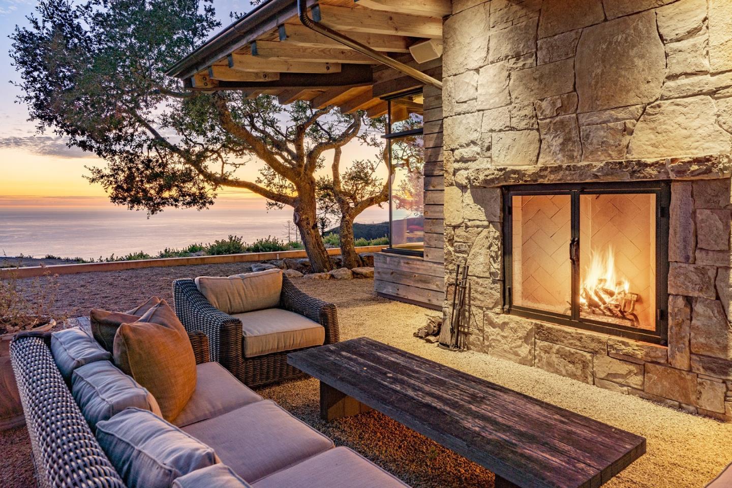 a terrace with outdoor seating and trees