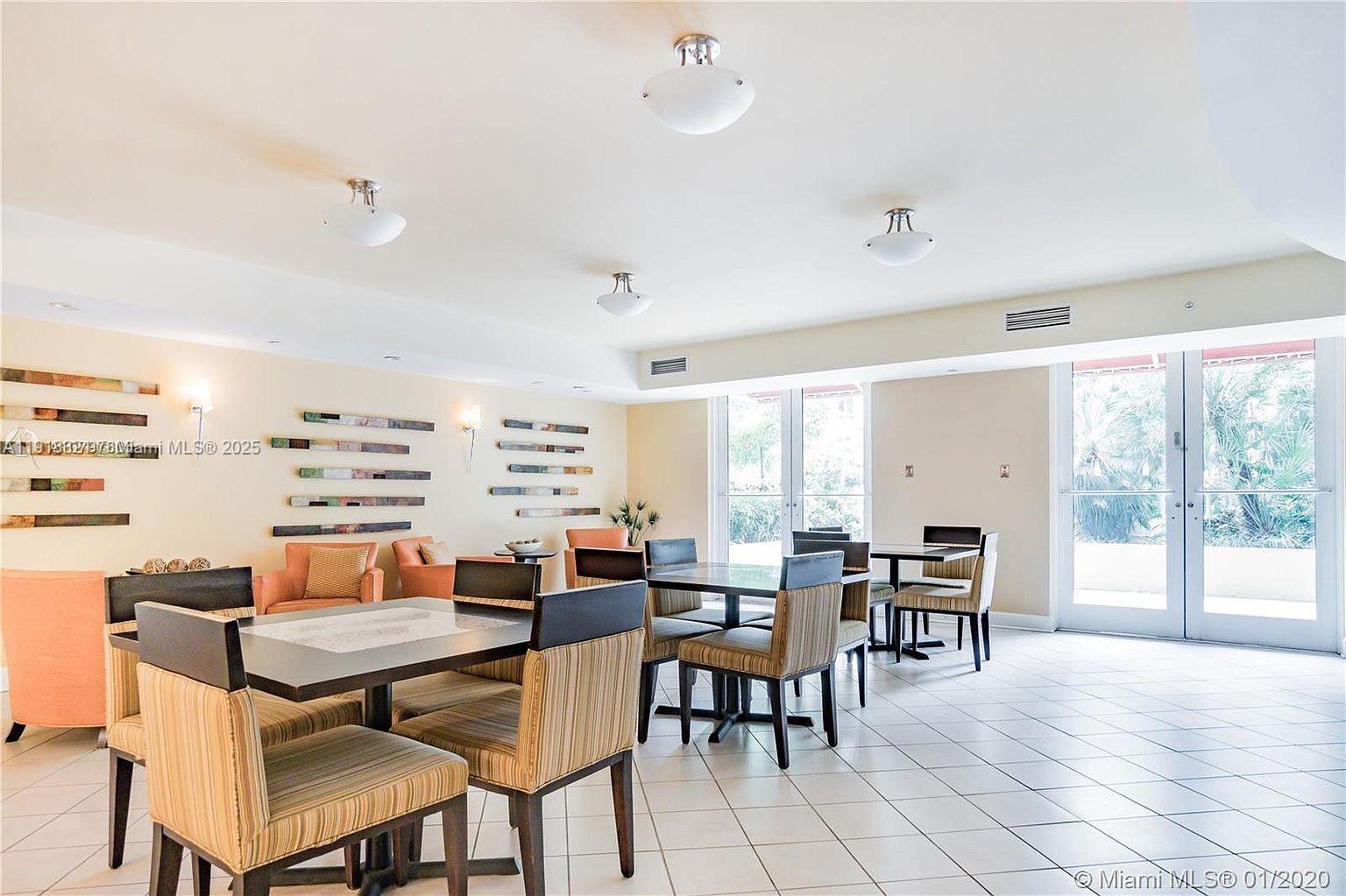 7350 Southwest 89th Street, Unit 408S Miami, FL 33156 - Photo 16 of 19 a dining room with furniture and a floor to ceiling window