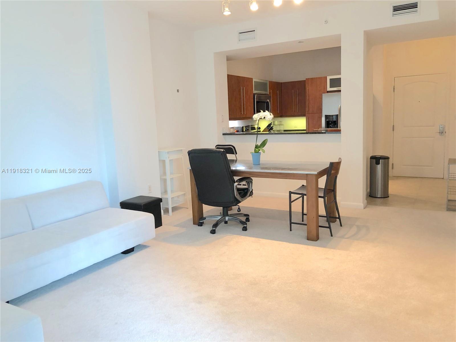 7350 Southwest 89th Street, Unit 408S Miami, FL 33156 - Photo 4 of 19 a living room with furniture and a table