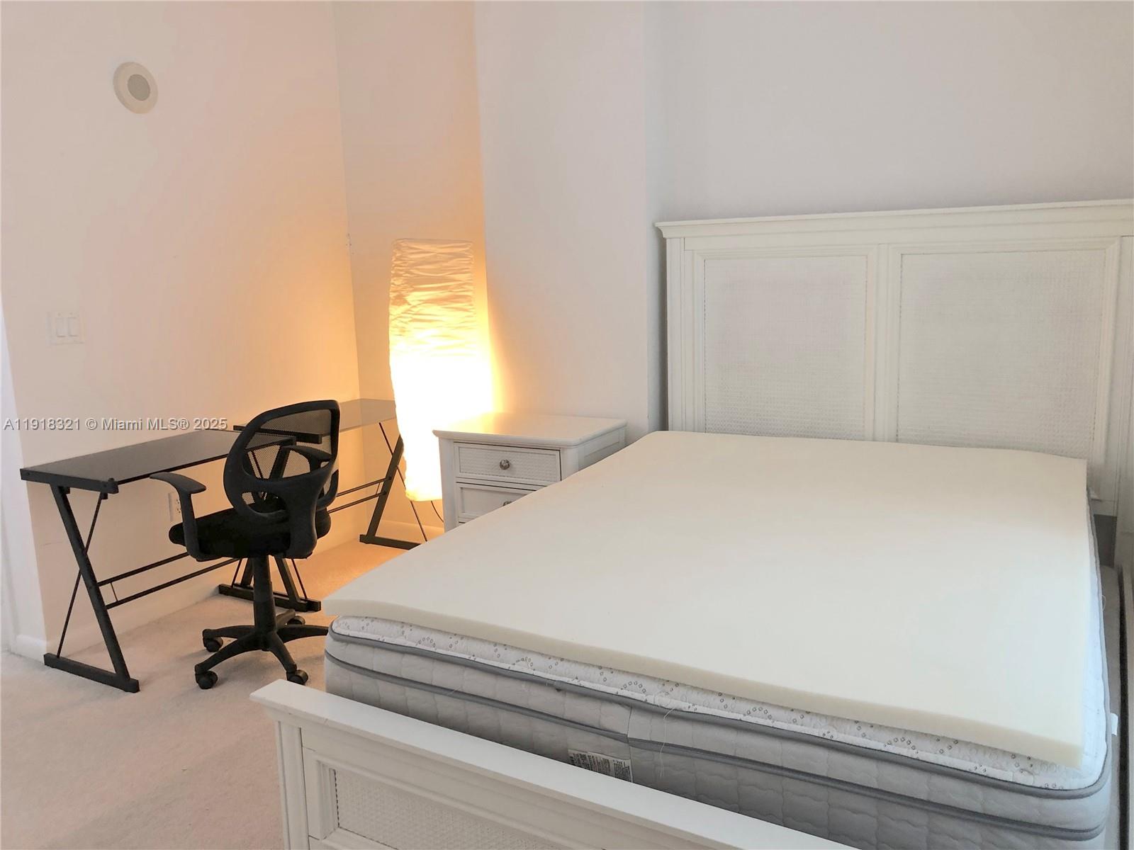 7350 Southwest 89th Street, Unit 408S Miami, FL 33156 - Photo 6 of 19 a bedroom with a bed and a chandelier