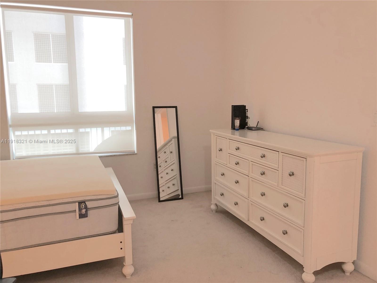 7350 Southwest 89th Street, Unit 408S Miami, FL 33156 - Photo 7 of 19 a room with cabinets and a window