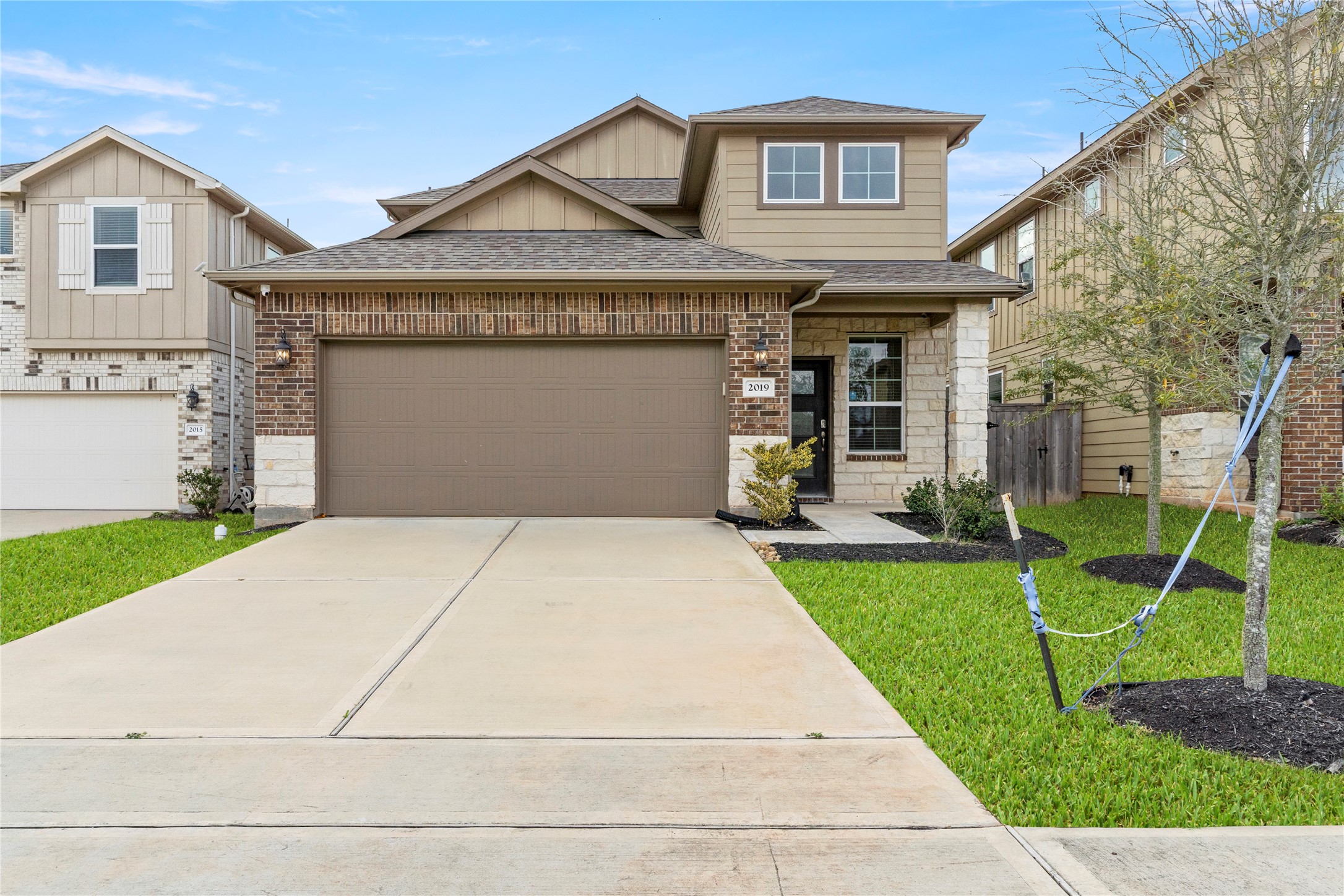 a front view of a house with a yard and garage