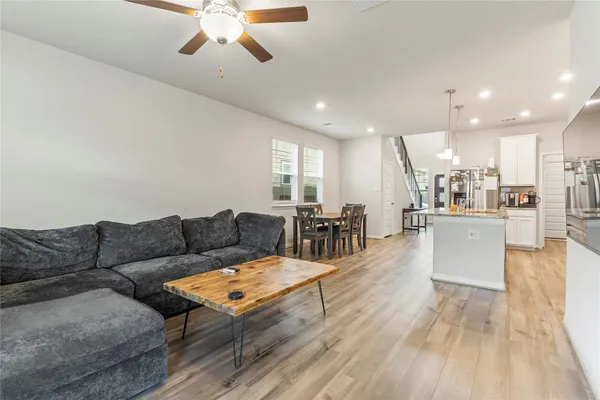a living room with furniture and kitchen view