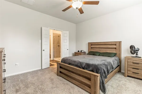 a bedroom with a bed and ceiling fan