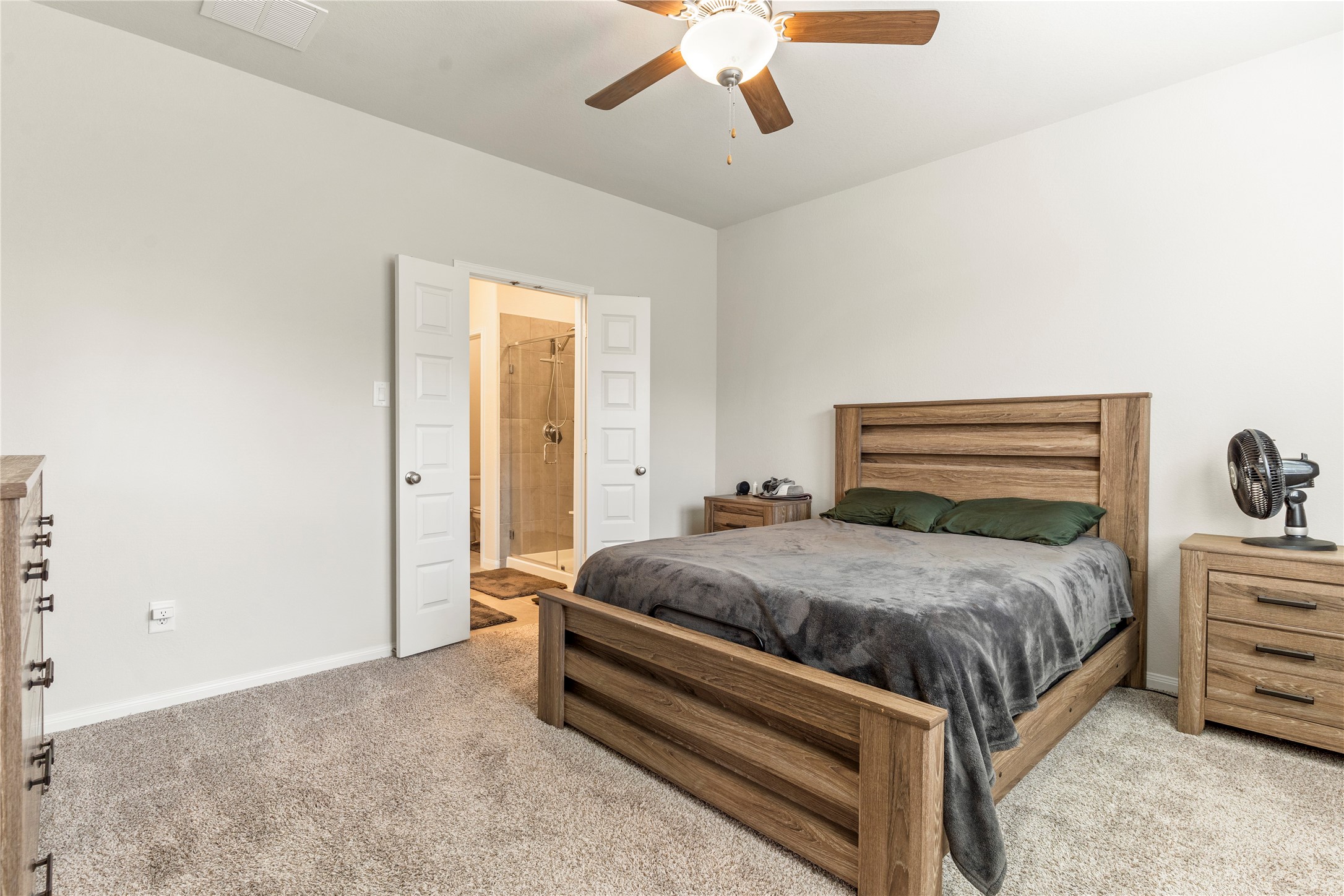 2019 Myrtle Oak Street Conroe, TX 77304 - Photo 13 of 23 a bedroom with a bed and ceiling fan