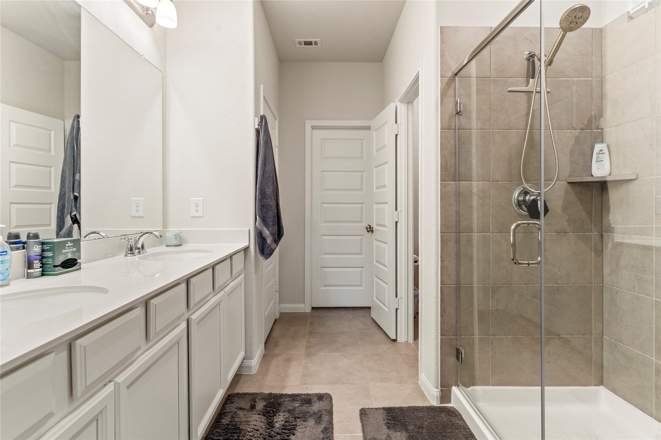 2019 Myrtle Oak Street Conroe, TX 77304 - Photo 14 of 23 a bathroom with a double vanity sink mirror and shower