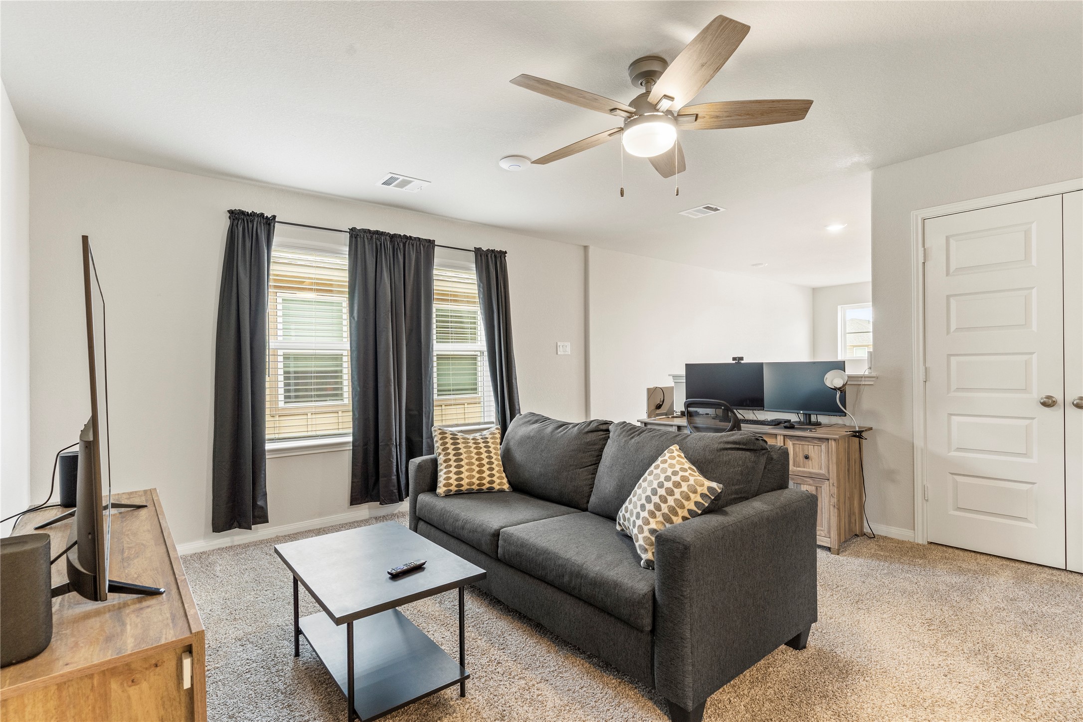 2019 Myrtle Oak Street Conroe, TX 77304 - Photo 15 of 23 a living room with furniture and a flat screen tv