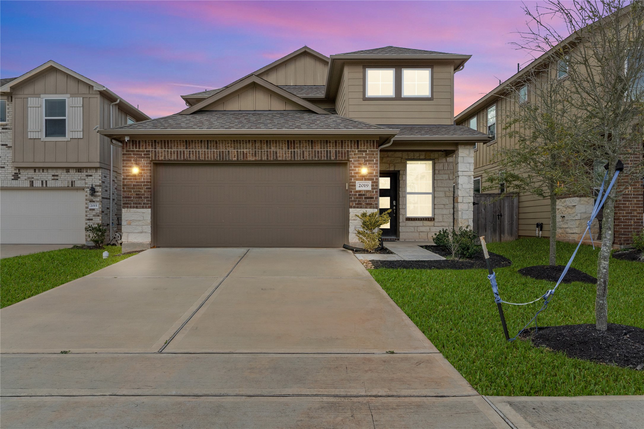 2019 Myrtle Oak Street Conroe, TX 77304 - Photo 23 of 23 a front view of a house with a yard and garage