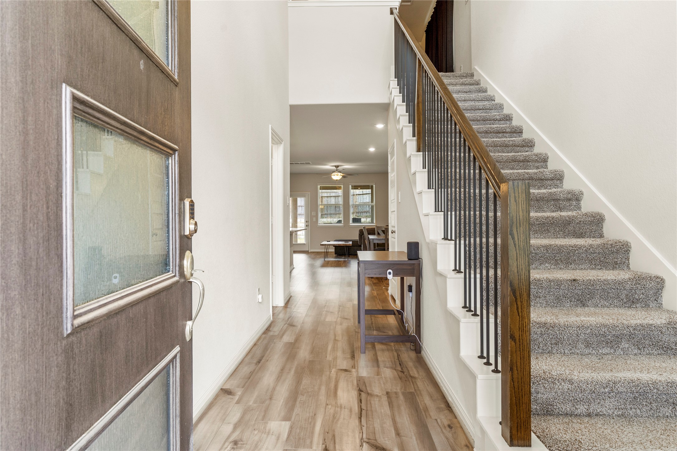 2019 Myrtle Oak Street Conroe, TX 77304 - Photo 3 of 23 a view of a hallway with wooden floor and staircase