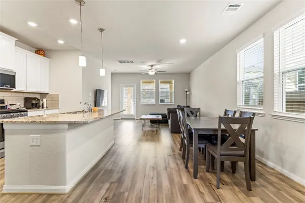 a large kitchen with a table and chairs in it