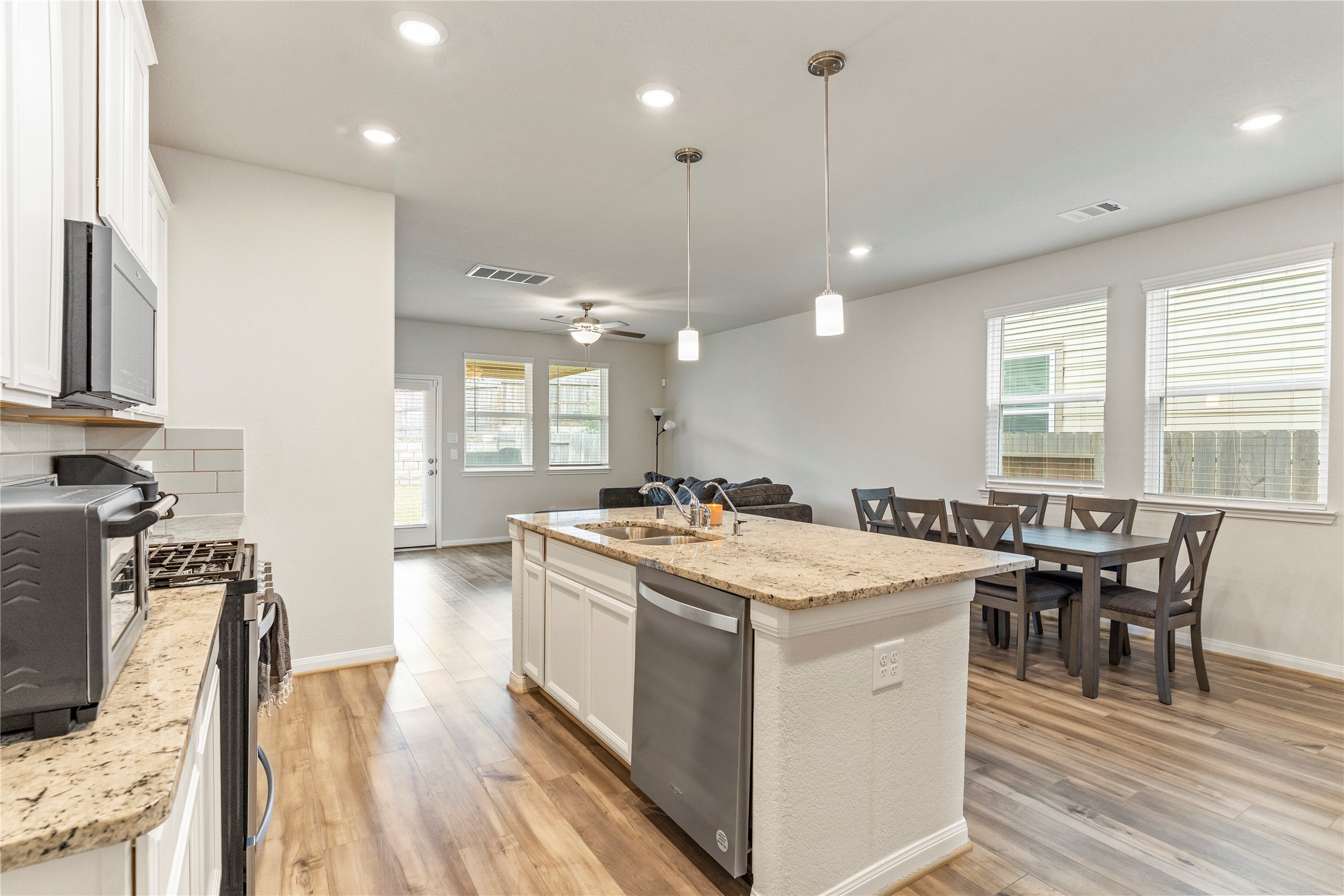 2019 Myrtle Oak Street Conroe, TX 77304 - Photo 8 of 23 a kitchen with a stove a table and chairs