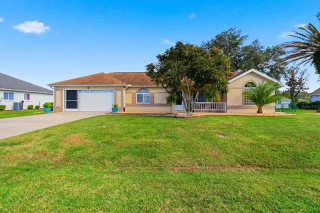 a front view of house with yard and green space