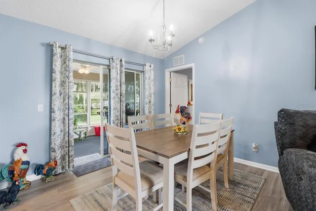 a view of a dining room with furniture and chandelier