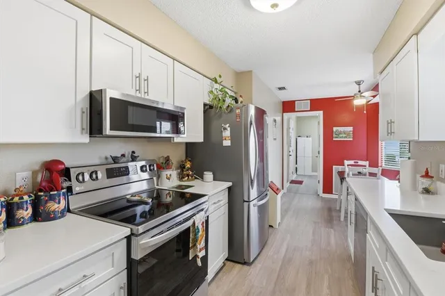 a kitchen with a sink stove and refrigerator