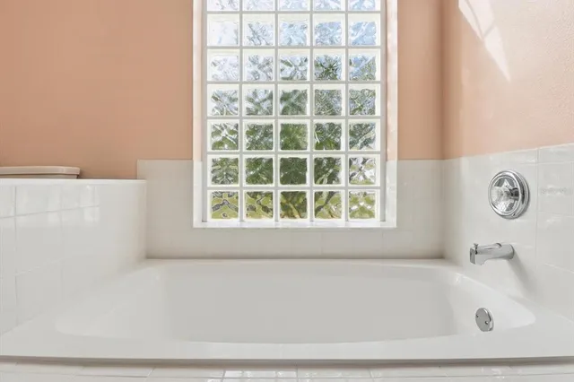 a white bath tub sitting next to a window