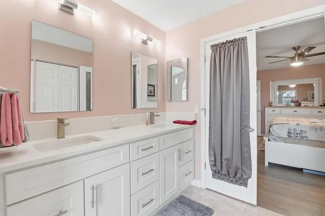a bathroom with a granite countertop sink mirror and double