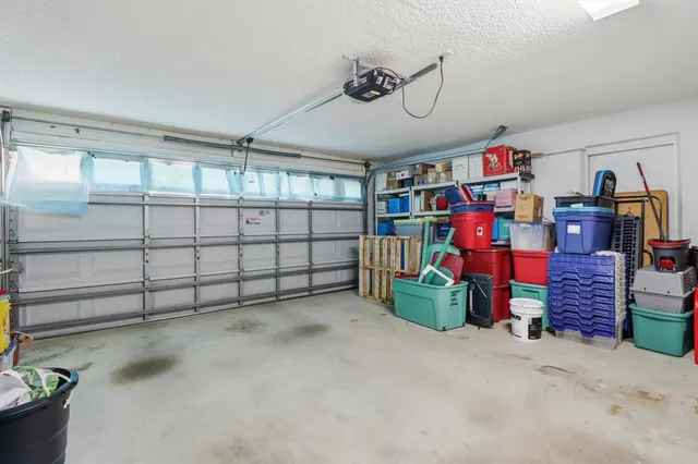 a front view of a house with a garden and trees