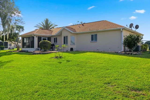 an aerial view of multiple houses with yard