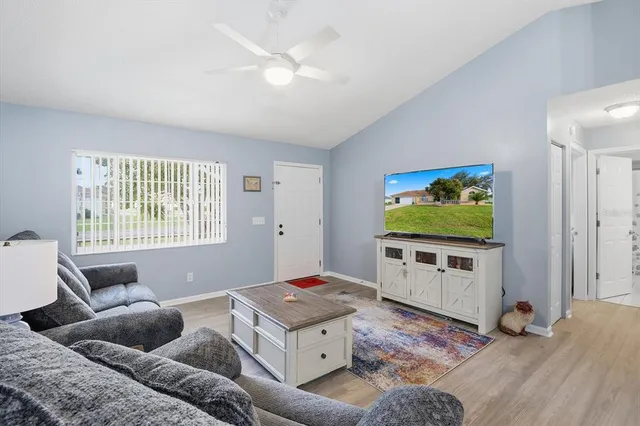 a living room with furniture and a flat screen tv