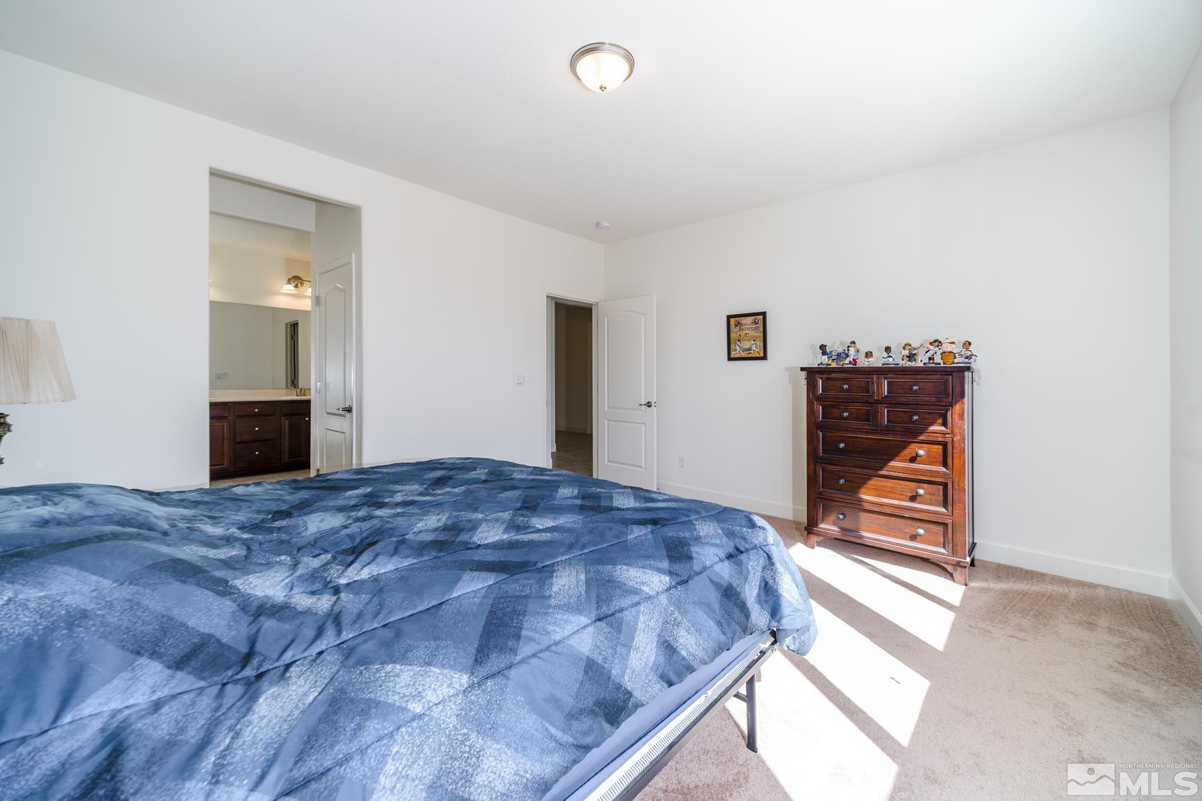6758 Eagle Peak Drive Carson City, NV 89701 - Photo 15 of 28 a bedroom with a bed and a dresser