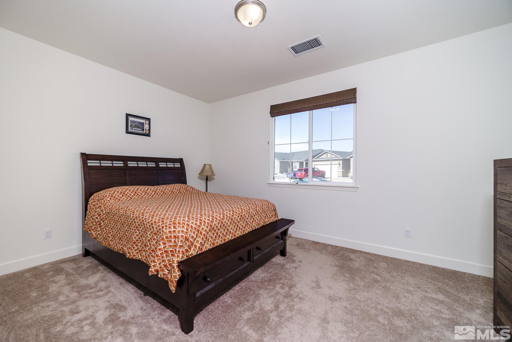 6758 Eagle Peak Drive Carson City, NV 89701 - Photo 22 of 28 a bed sitting in a bedroom next to a window