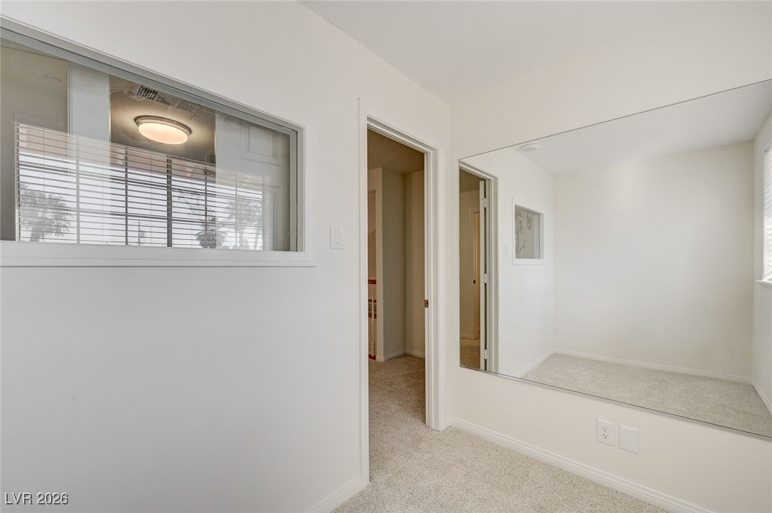 2955 El Camino Road Las Vegas, NV 89146 - Photo 68 of 99 Hallway featuring light carpet and baseboards