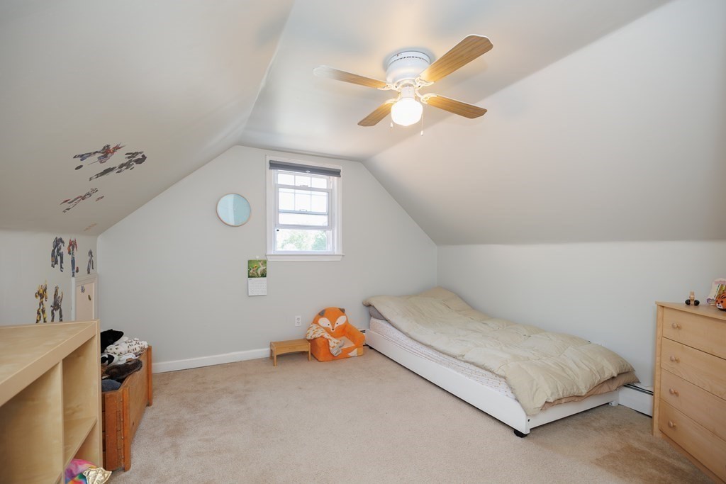 110 Chester Street Worcester, MA 01605 - Photo 15 of 19 a bedroom with a bed and a chandelier