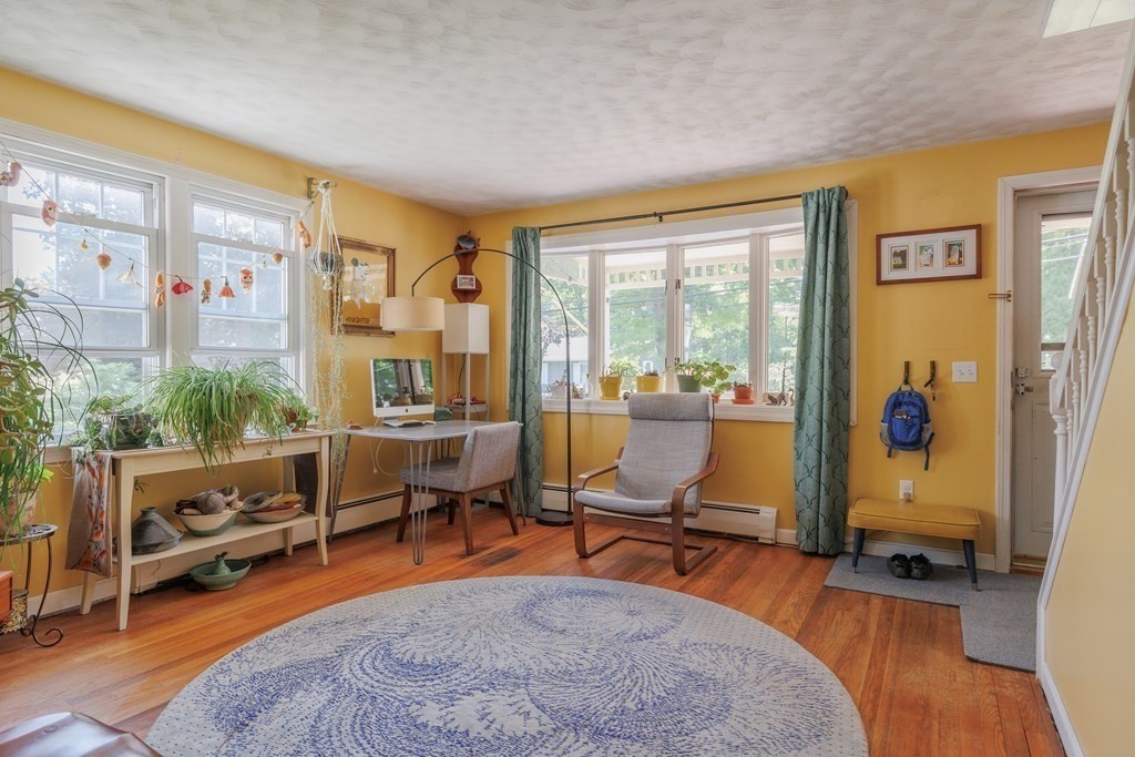 110 Chester Street Worcester, MA 01605 - Photo 5 of 19 a living room with furniture a rug kitchen view and large windows