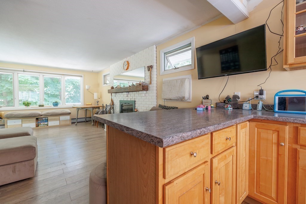 110 Chester Street Worcester, MA 01605 - Photo 7 of 19 a kitchen with stainless steel appliances granite countertop a sink dishwasher stove and microwave with wooden floor