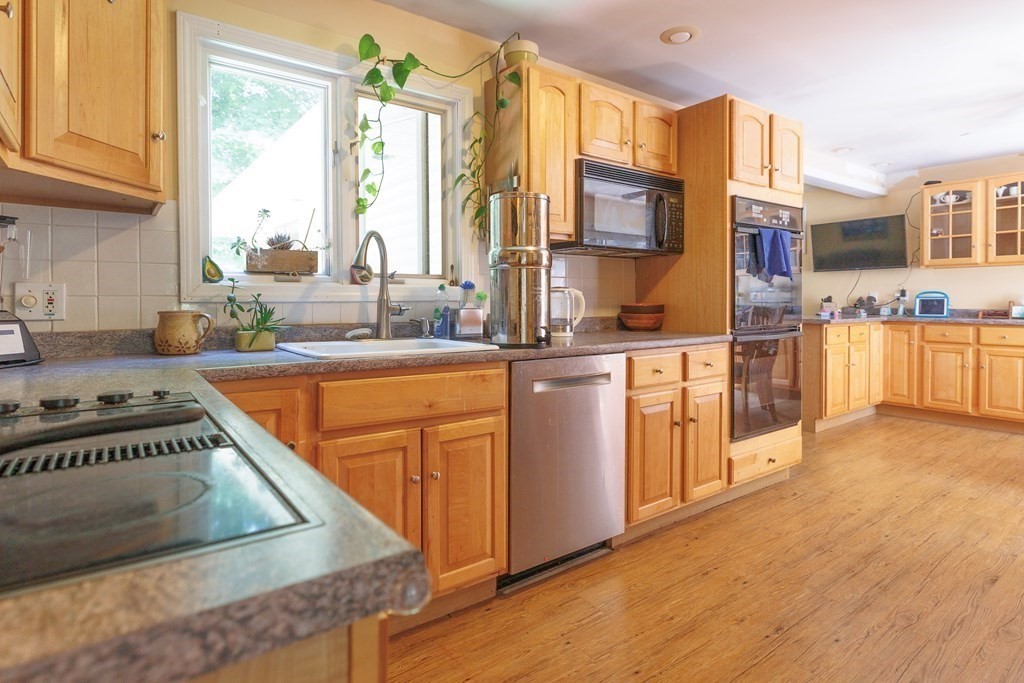 110 Chester Street Worcester, MA 01605 - Photo 8 of 19 a kitchen with stainless steel appliances granite countertop a stove a sink and a microwave