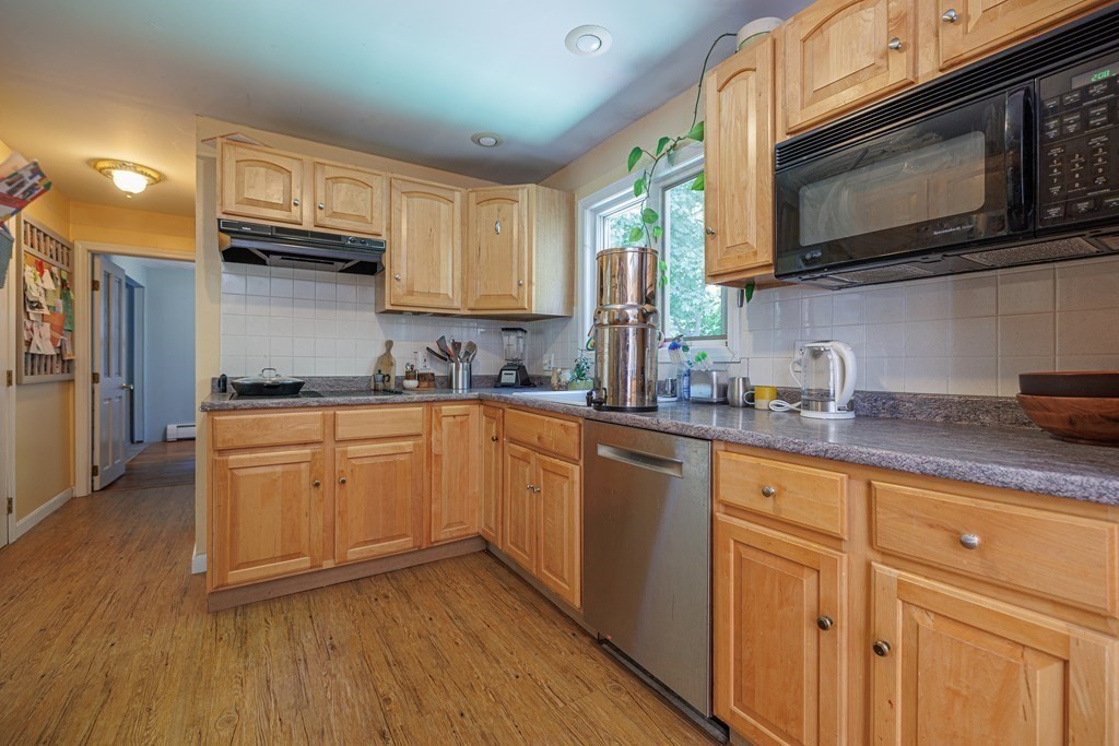110 Chester Street Worcester, MA 01605 - Photo 9 of 19 a kitchen with granite countertop cabinets stainless steel appliances a sink and wooden floor