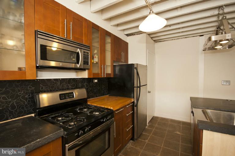 3629 Yolando Road Baltimore, MD 21218 - Photo 6 of 18 a kitchen with stainless steel appliances granite countertop a stove and a microwave