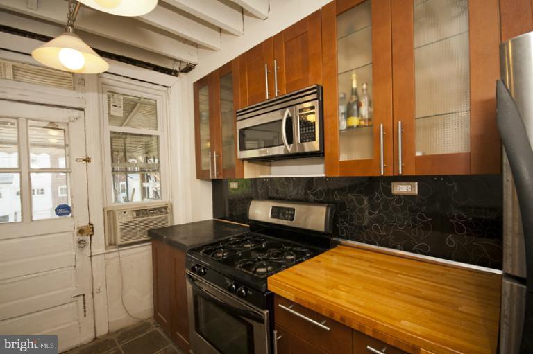 3629 Yolando Road Baltimore, MD 21218 - Photo 7 of 18 a kitchen with stainless steel appliances granite countertop a stove and a microwave