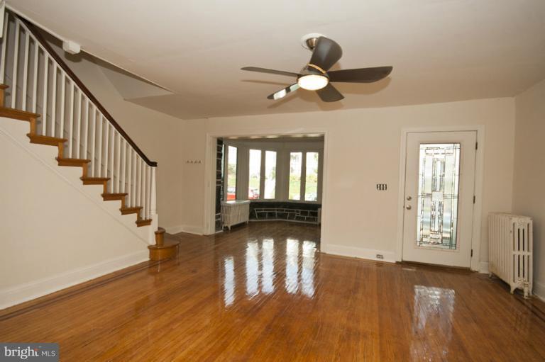 3629 Yolando Road Baltimore, MD 21218 - Photo 10 of 18 a view of an empty room with wooden floor and a window