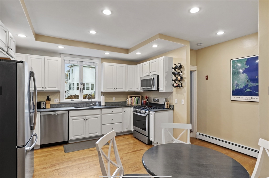 45 Walnut Road Hamilton, MA 01982 - Photo 3 of 40 a kitchen with stainless steel appliances granite countertop a refrigerator a stove top oven a sink dishwasher and white cabinets with wooden floor