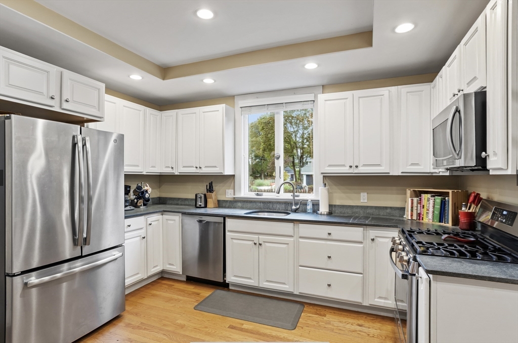 45 Walnut Road Hamilton, MA 01982 - Photo 4 of 40 a kitchen with white cabinets stainless steel appliances a sink and a window