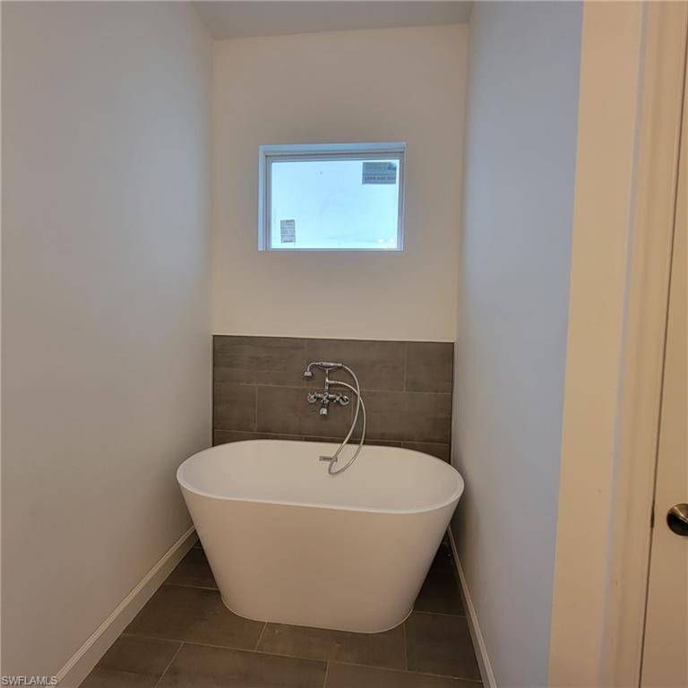 1900 West 16th Street Lehigh Acres, FL 33972 - Photo 13 of 21 a bathroom with a granite countertop sink and mirror