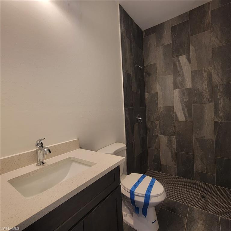 1900 West 16th Street Lehigh Acres, FL 33972 - Photo 16 of 21 a bathroom with a sink and mirror