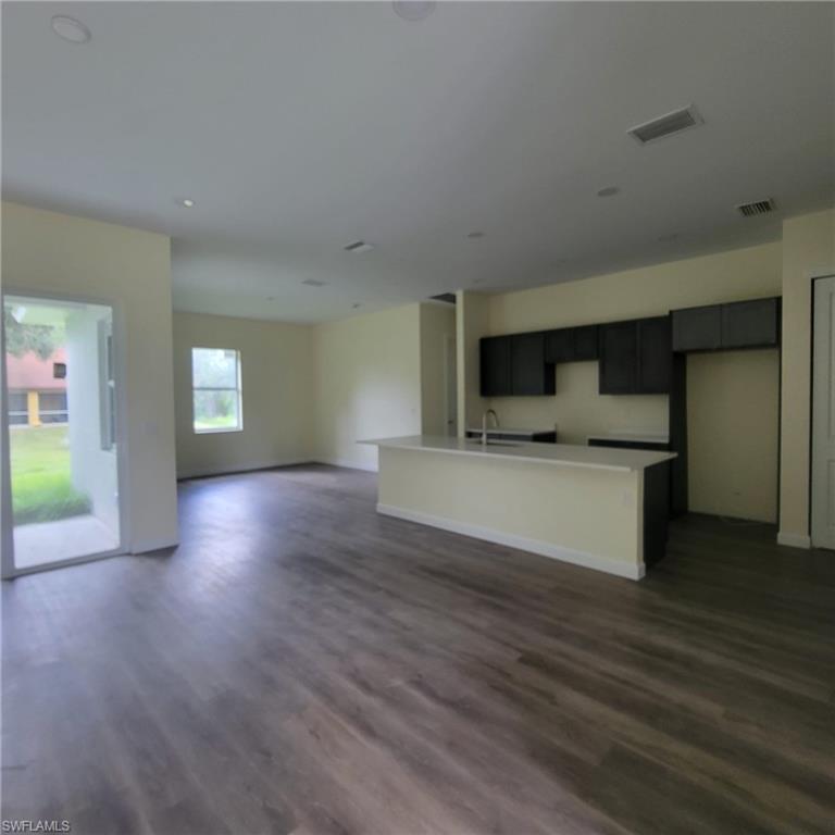 1900 West 16th Street Lehigh Acres, FL 33972 - Photo 3 of 21 a view of kitchen with cabinets and wooden floor