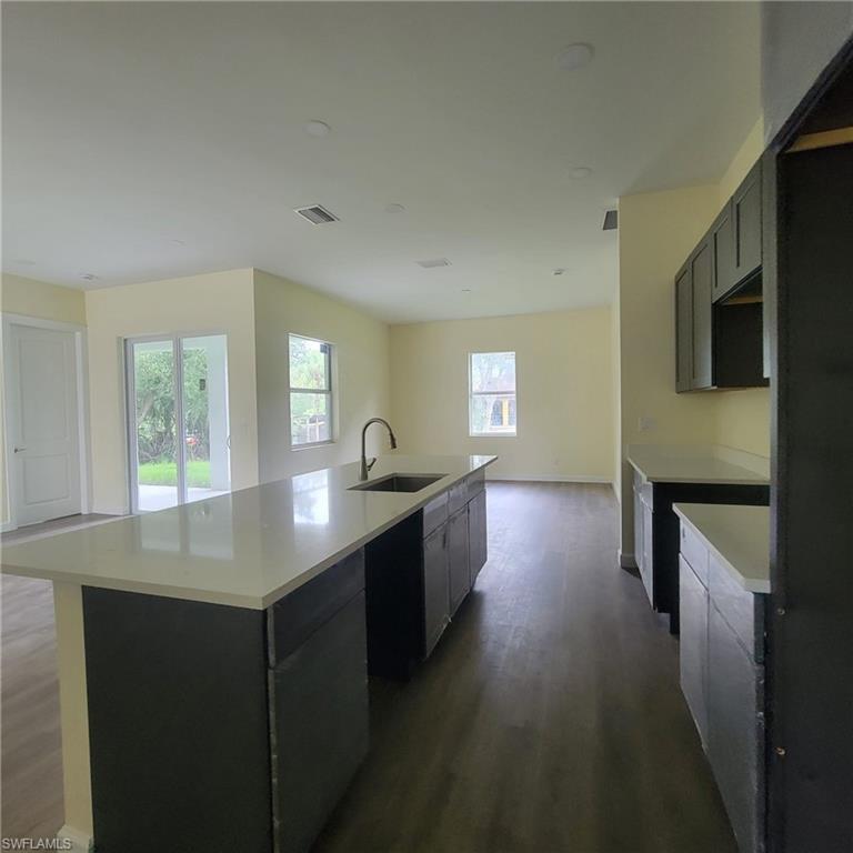 1900 West 16th Street Lehigh Acres, FL 33972 - Photo 5 of 21 a kitchen with a sink and cabinets