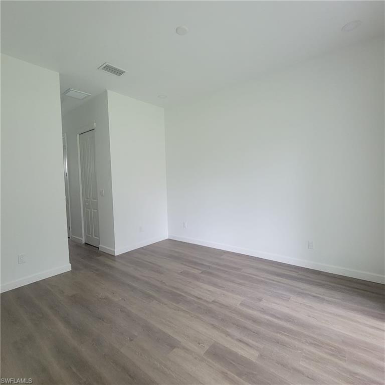 1900 West 16th Street Lehigh Acres, FL 33972 - Photo 7 of 21 a view of an empty room with wooden floor