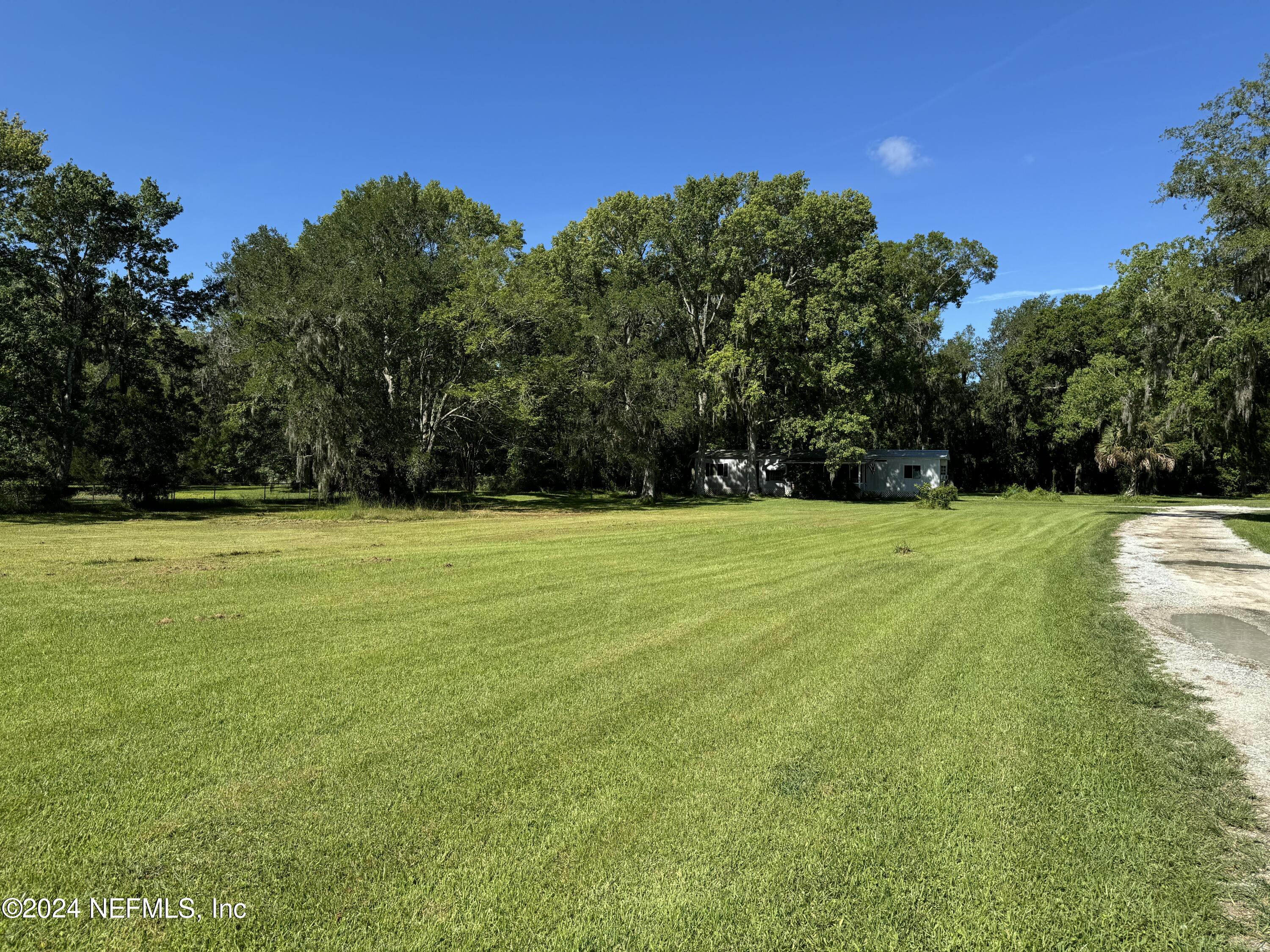 2015 Powell Road St. Augustine, FL 32084 - Photo 4 of 8 a view of a tennis ground with trees in the background