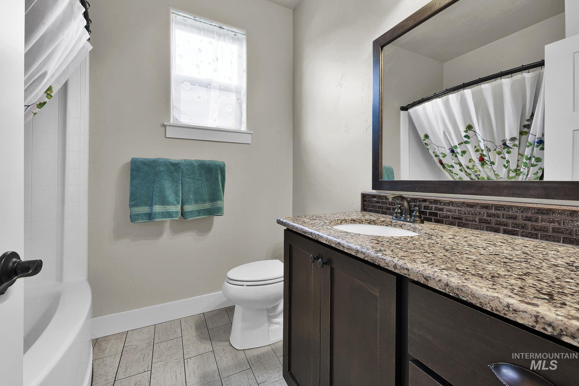 220 South Wildgrass Way Star, ID 83669 - Photo 29 of 50 Built-in wood-finish cabinetry featuring a folding desk