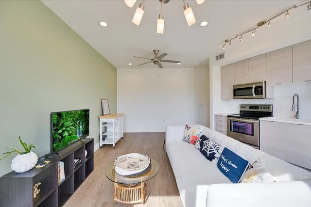 a living room with furniture a fireplace and a flat screen tv