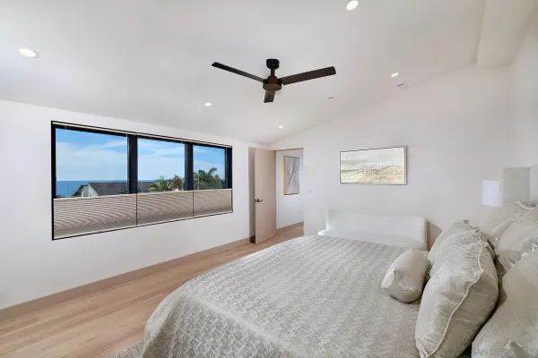 a bedroom with a large bed and a large window